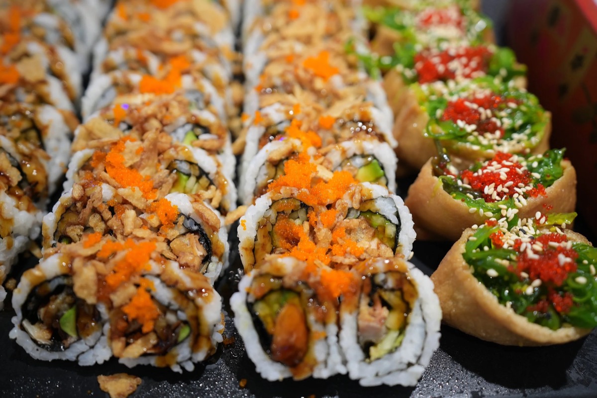 Specialty sushi rolls lined up at the sushi bar